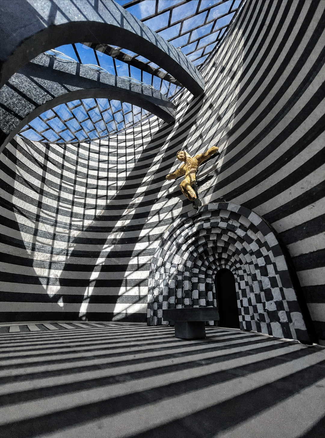 Black-and-white striped architectural model with a small gold figure